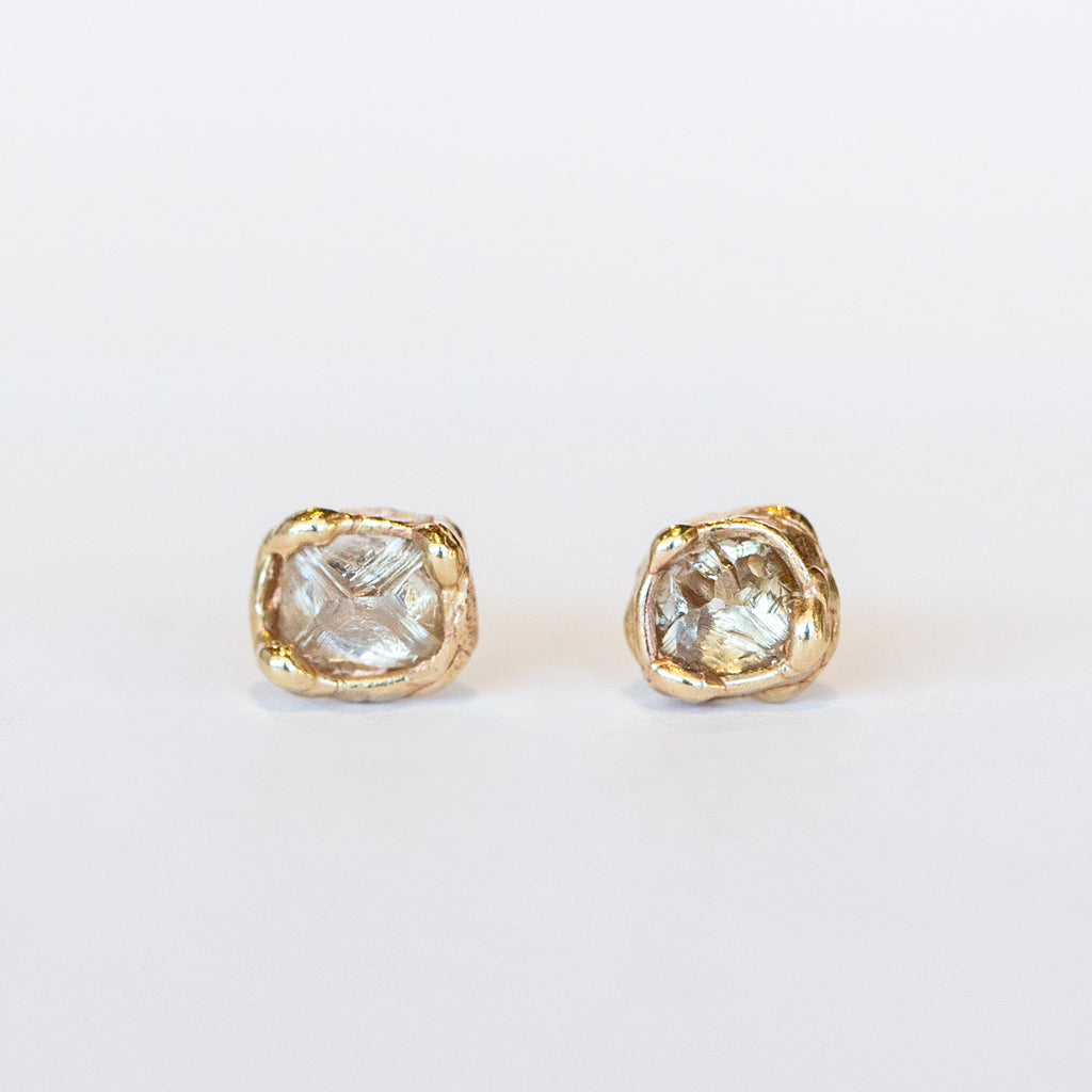 Raw champagne diamond stud earrings set in organic designed yellow gold.