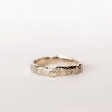 A hand carved 4mm width wedding band from Communion by Joy.