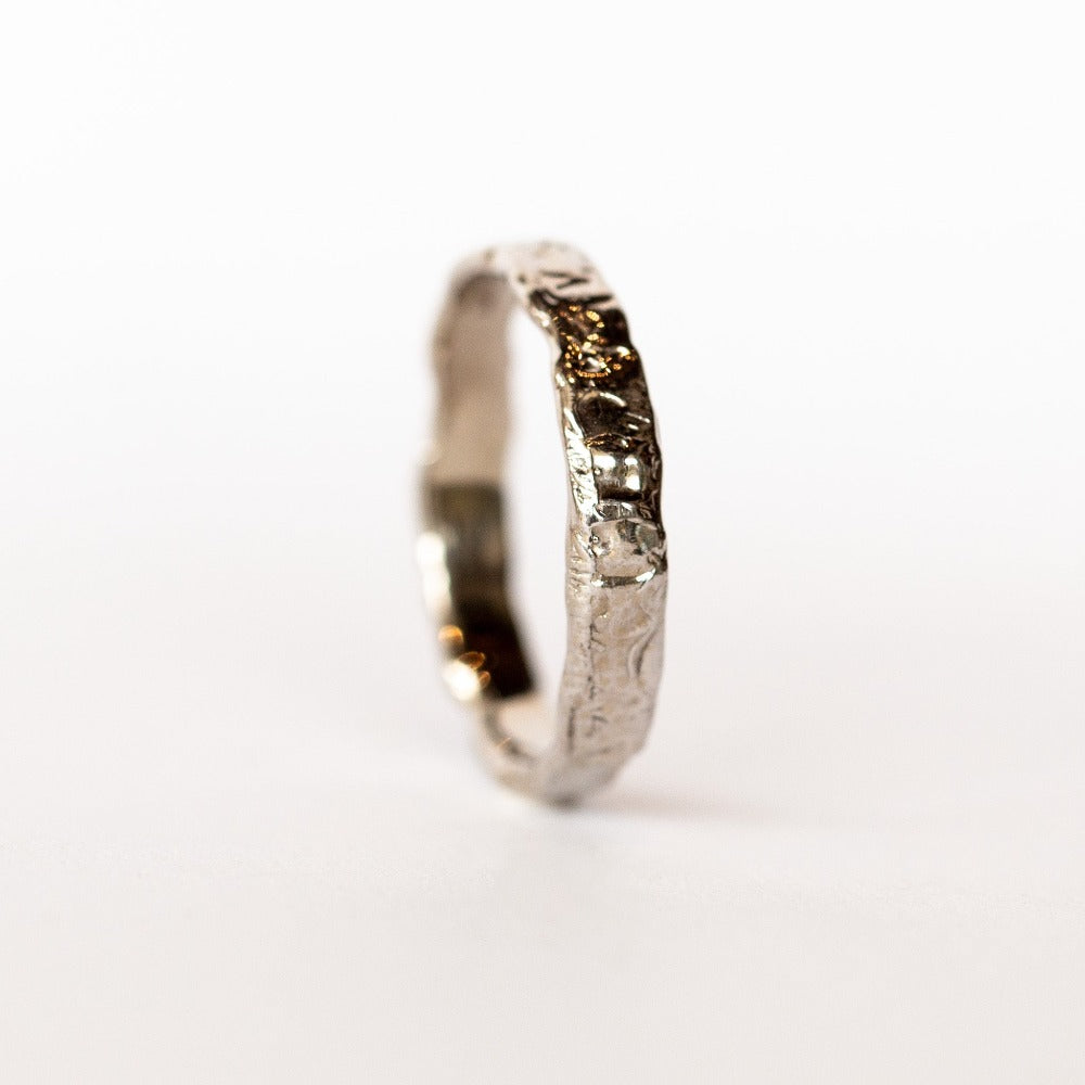 A hand carved 4mm width wedding band from Communion by Joy.