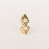 A pair of hand carved yellow gold stud earrings set with four small diamonds from Communion by Joy.