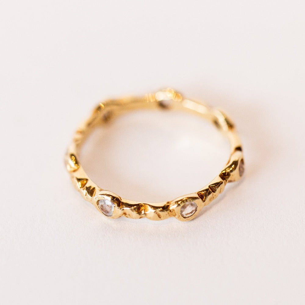 Communion by Joy eternity band, seven petite faceted moonstone gems are set in hand carved details.
