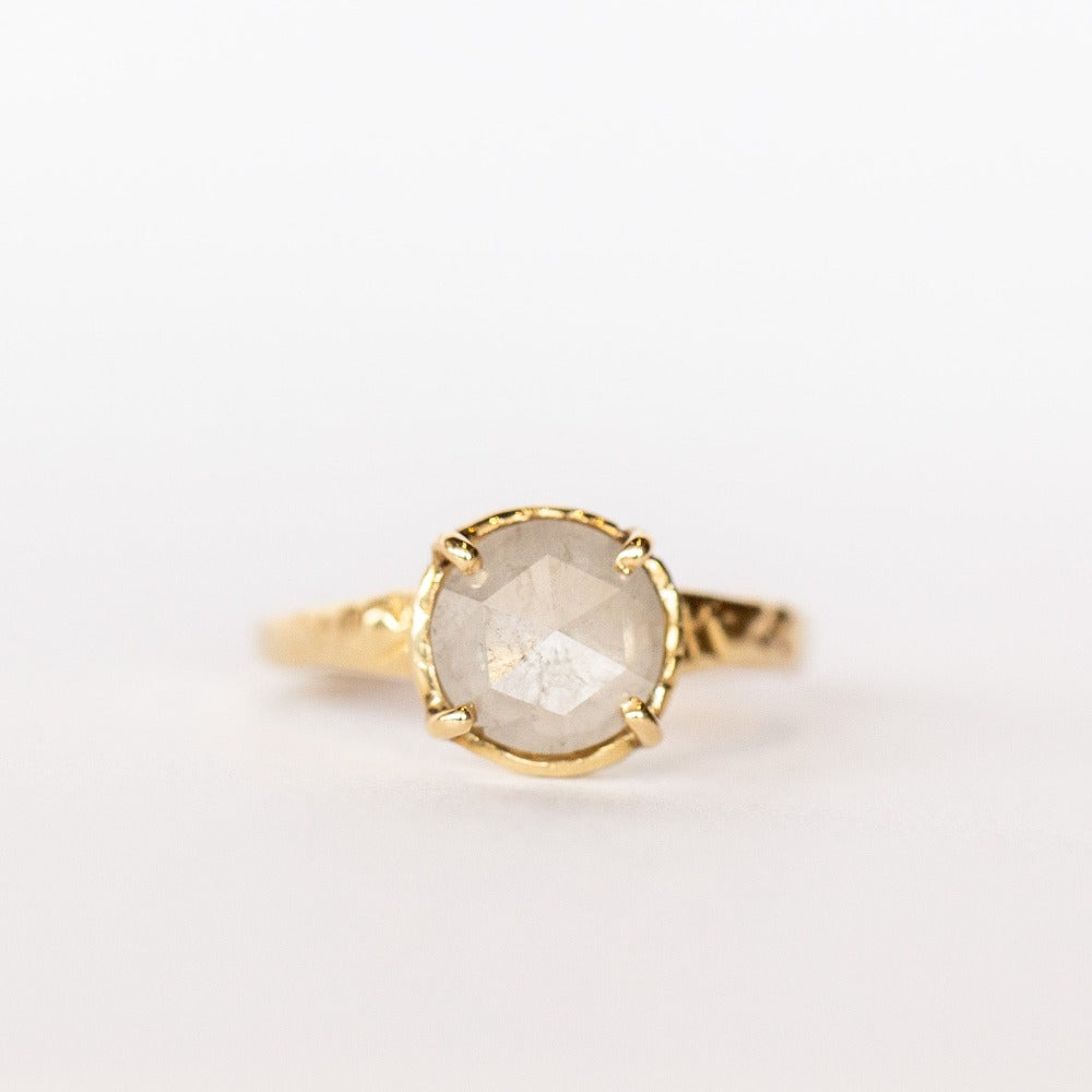 Front view of a hand carved yellow gold solitaire ring from Communion by Joy. It features an ice white rose-cut diamond.