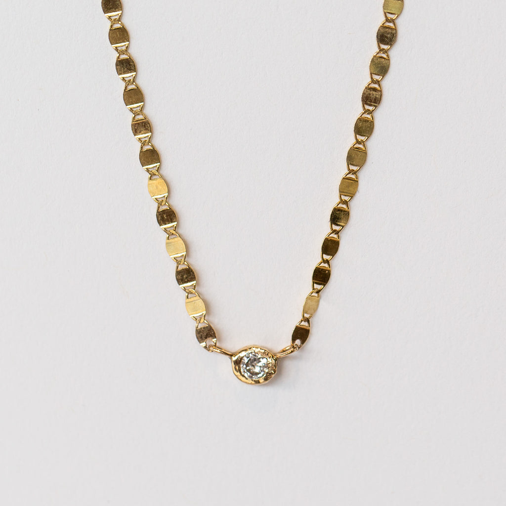A unique gold chain necklace with bezel set diamond from Communion by Joy.