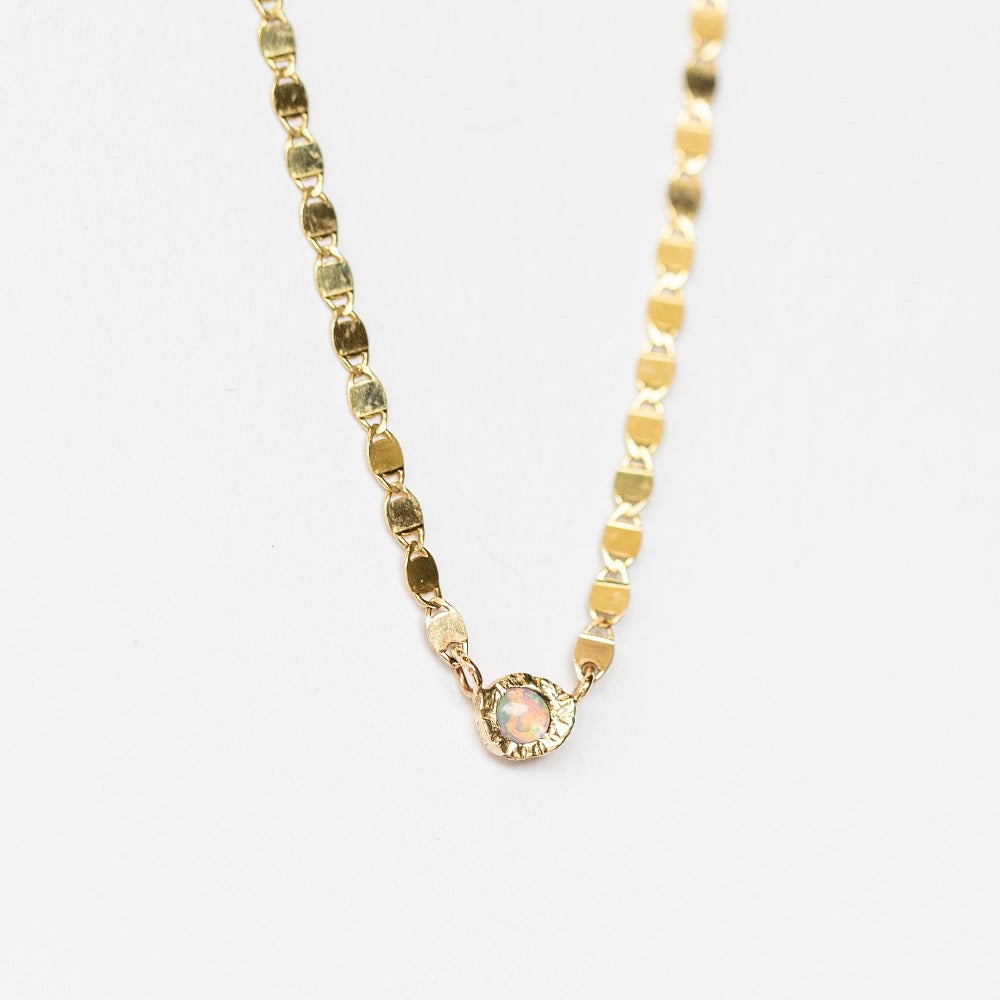Front view of yellow gold Communion by Joy necklace featuring flat chain links and a bezel set opal.