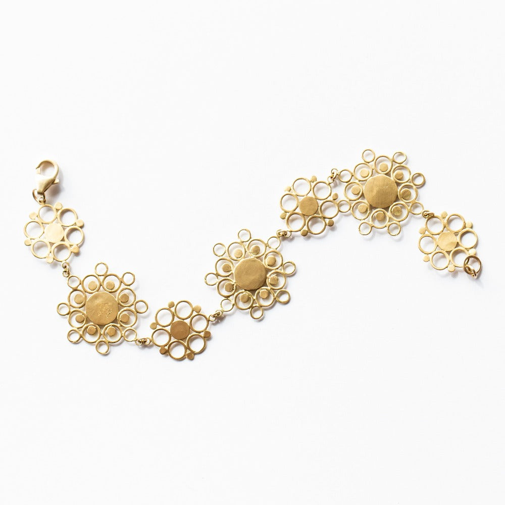 A chain bracelet made up of yellow gold, lace-like mandala shapes from Ananda Khalsa.