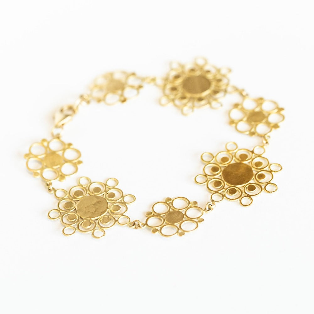 A chain bracelet made up of yellow gold, lace-like mandala shapes from Ananda Khalsa.