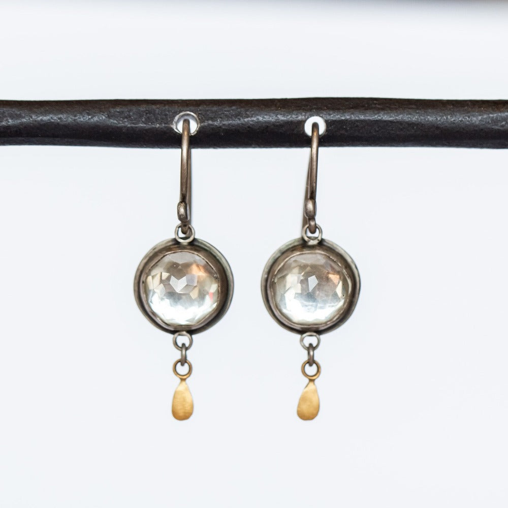 Round, rose cut white topaz gemstones are set in sterling silver and accented by 22k yellow gold drop details in these drop earrings on silver earhooks.