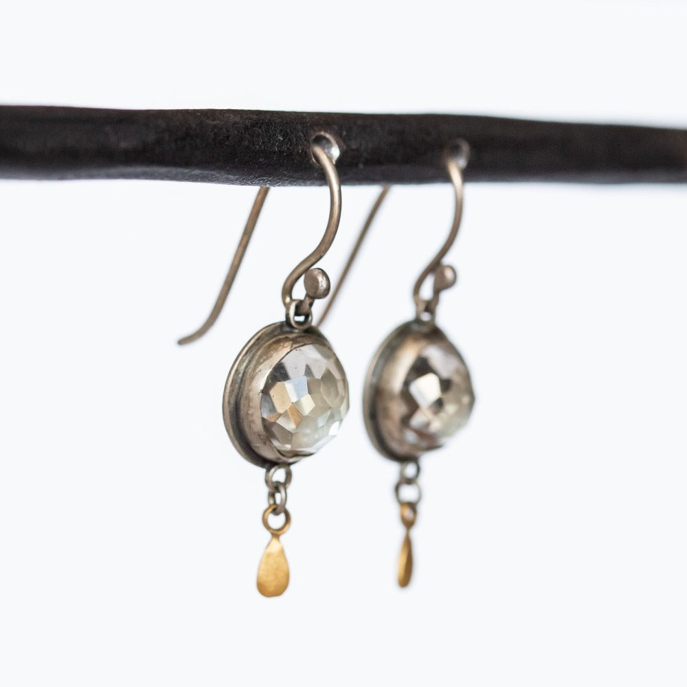 Round, rose cut white topaz gemstones are set in sterling silver and accented by 22k yellow gold drop details in these drop earrings on silver earhooks.