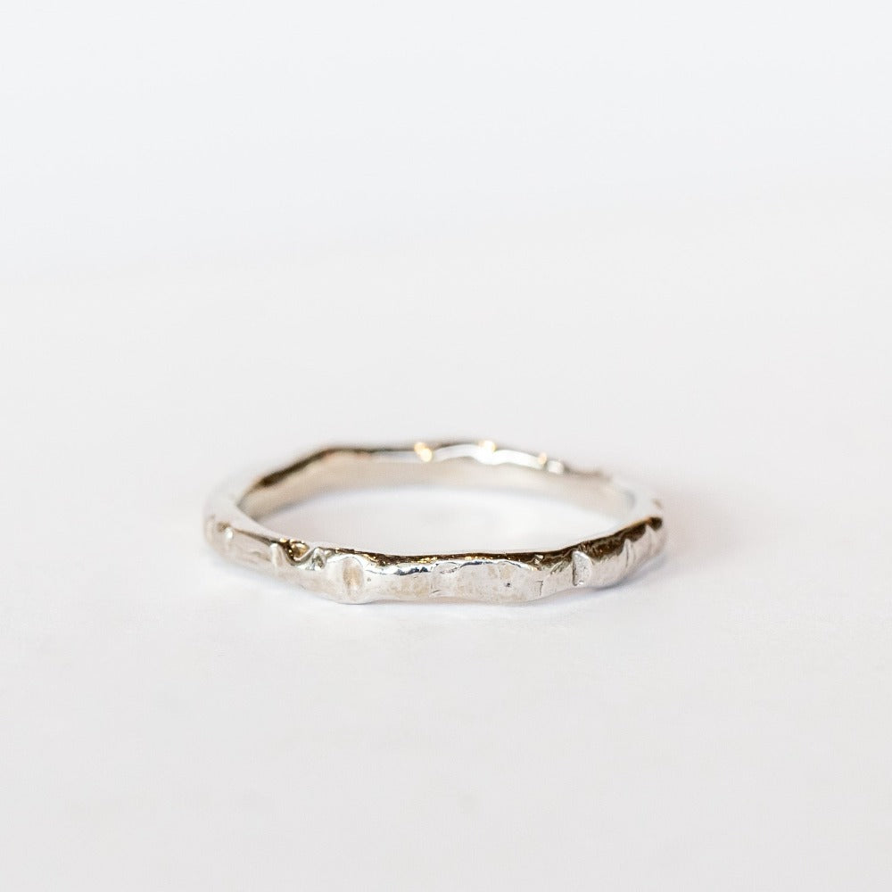 A thin hand carved band in white gold from Communion by Joy.