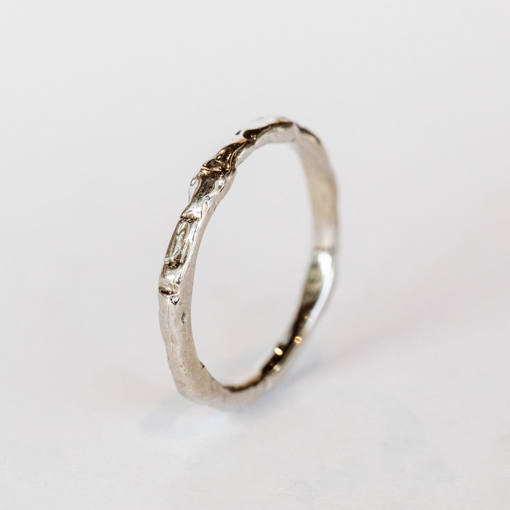 A thin hand carved band in white gold from Communion by Joy.