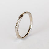 A thin hand carved band in white gold from Communion by Joy.