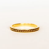 A rose gold wedding band with beaded detail all the way around and oxidized surface for contrast.