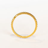 A rose gold wedding band with beaded detail all the way around and oxidized surface for contrast.