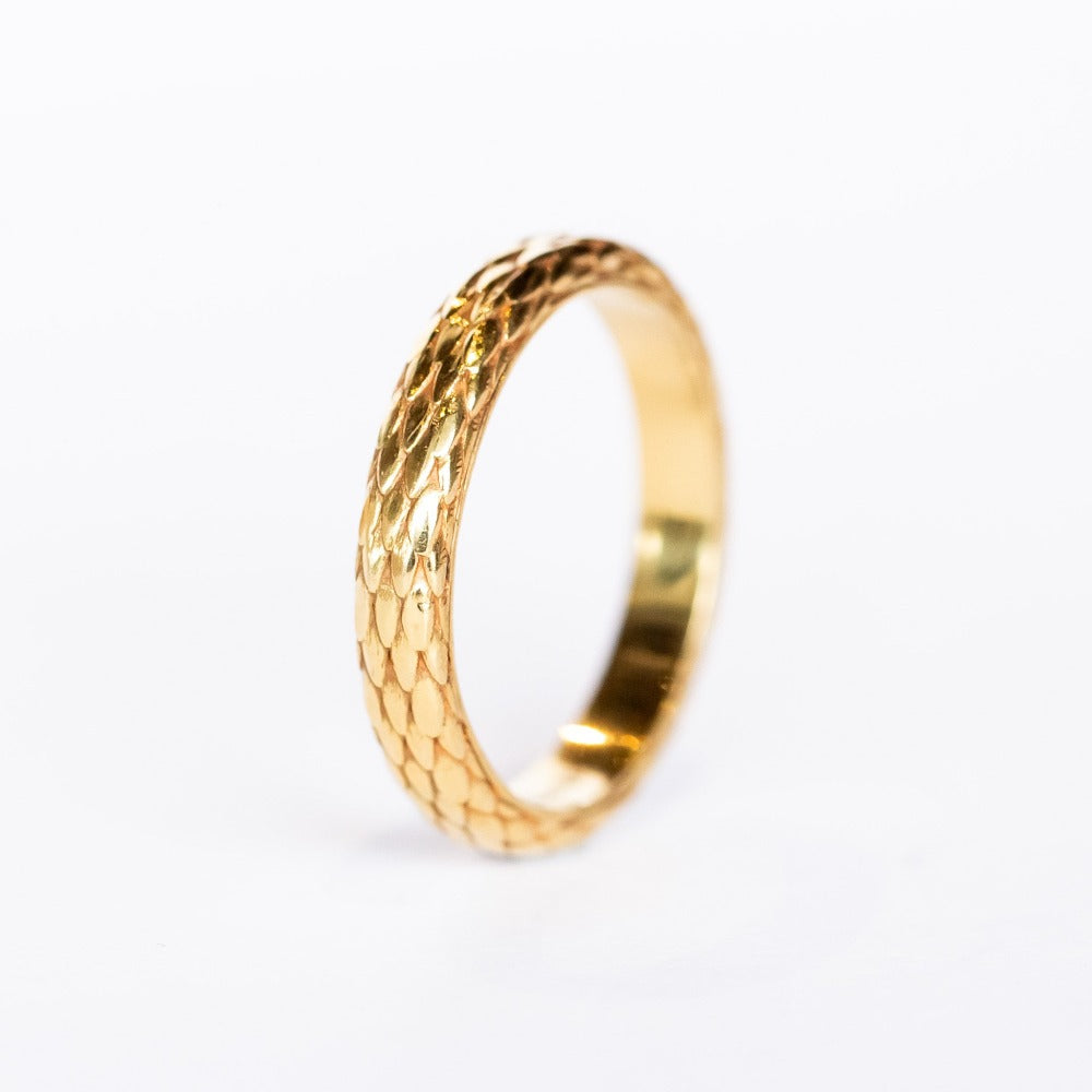 A wide yellow gold band with snakeskin scale pattern all the way around.