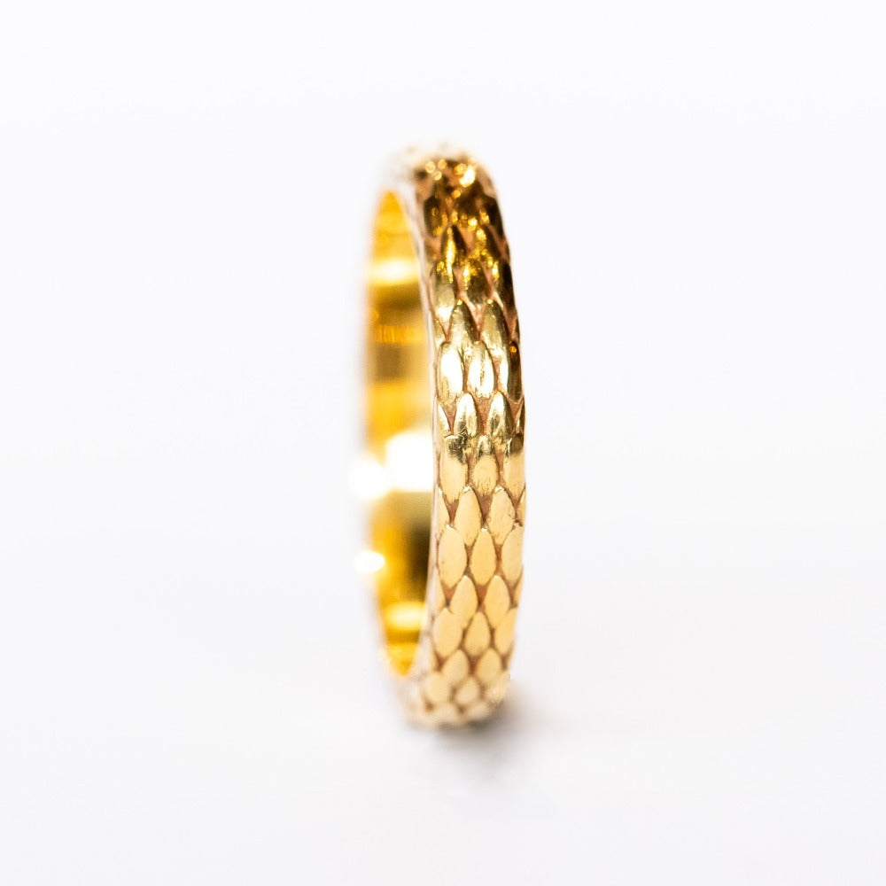 A wide yellow gold band with snakeskin scale pattern all the way around.