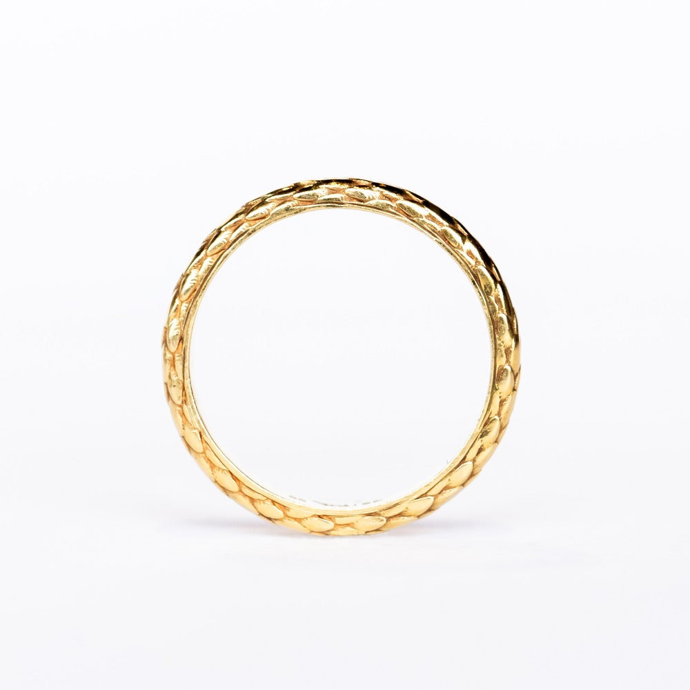 A wide yellow gold band with snakeskin scale pattern all the way around.