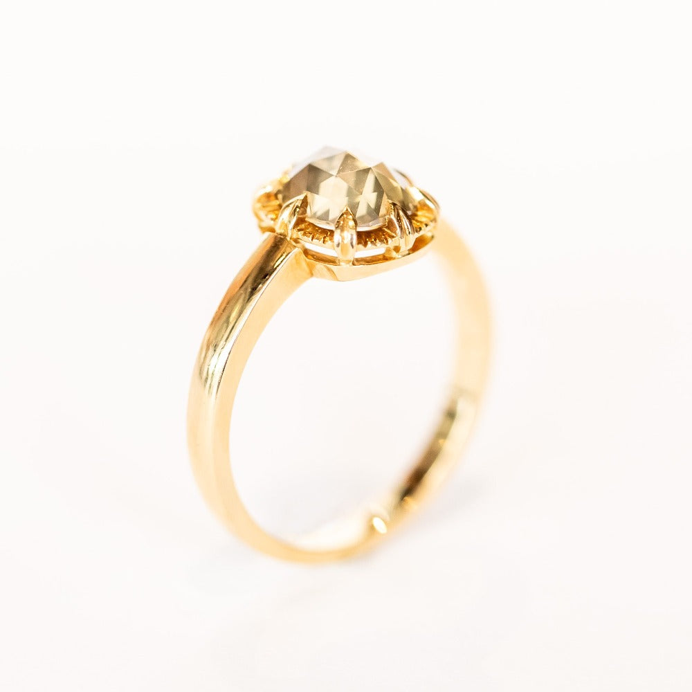 A rose cut cushion shaped diamond solitaire ring, set in an 8-prong, 18 karat yellow gold mounting.
