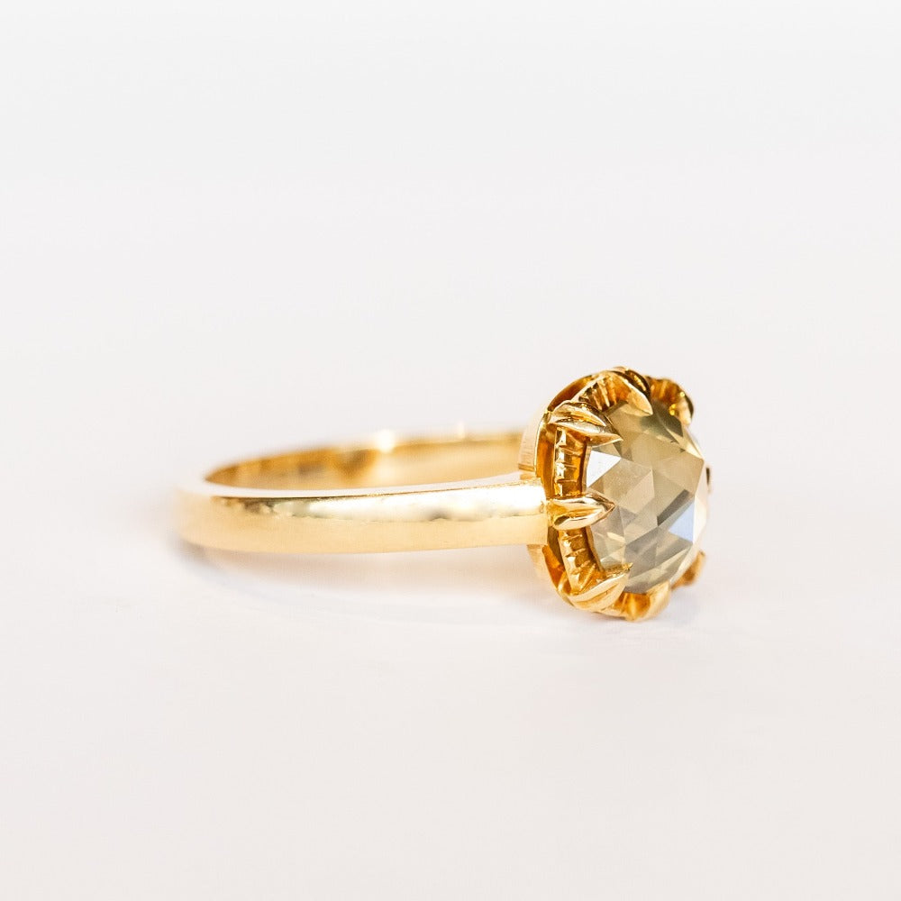 A rose cut cushion shaped diamond solitaire ring, set in an 8-prong, 18 karat yellow gold mounting.
