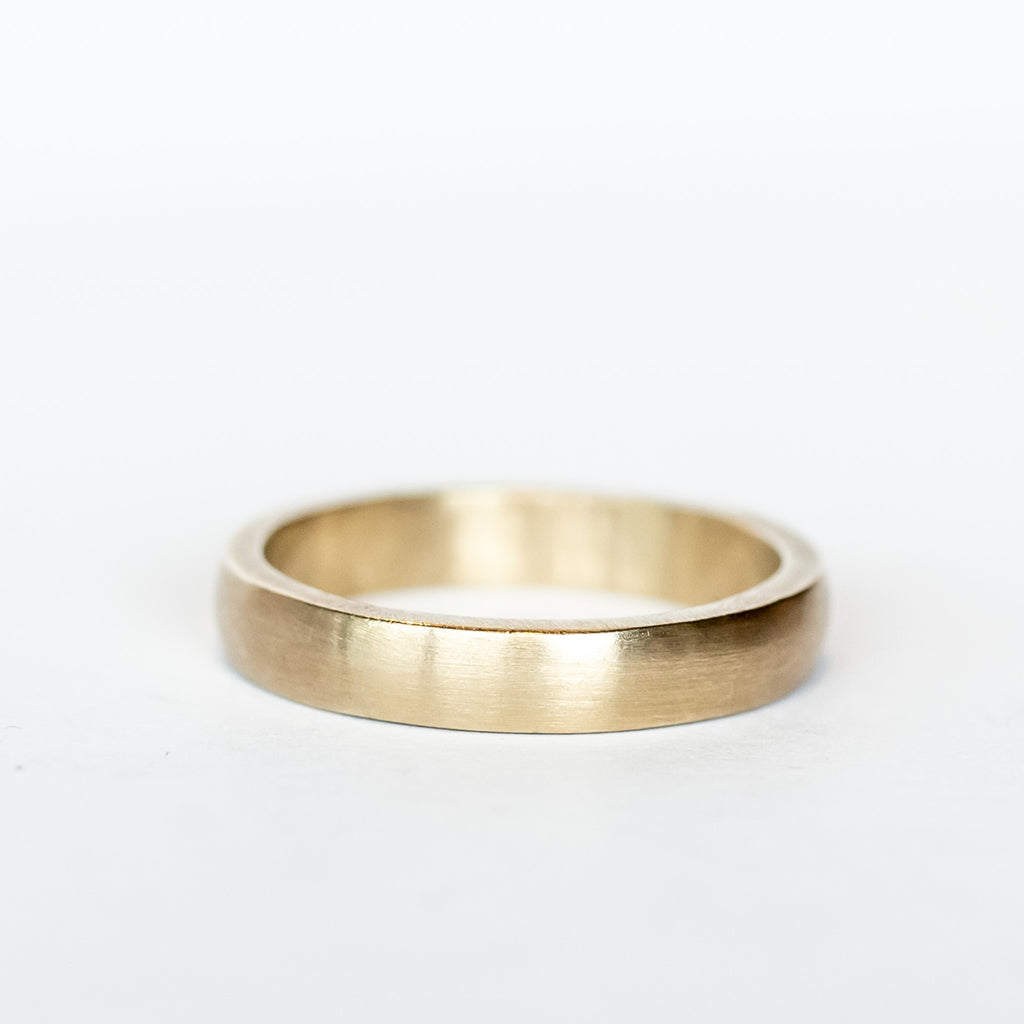 A brushed, matte finish wedding band made in champagne colored 18k white gold from Single Stone.