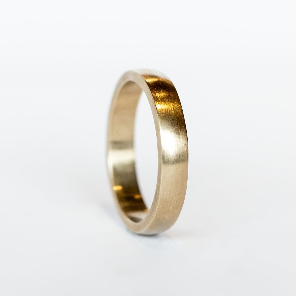 A brushed, matte finish wedding band made in champagne colored 18k white gold from Single Stone.