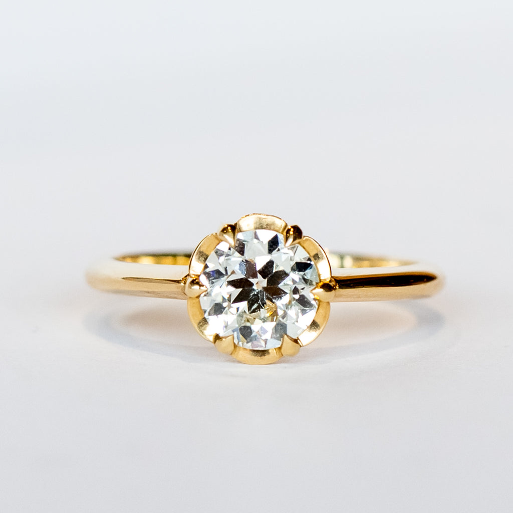 A yellow gold solitaire engagement ring with an old European cut diamond set in 6 dainty claw prongs.