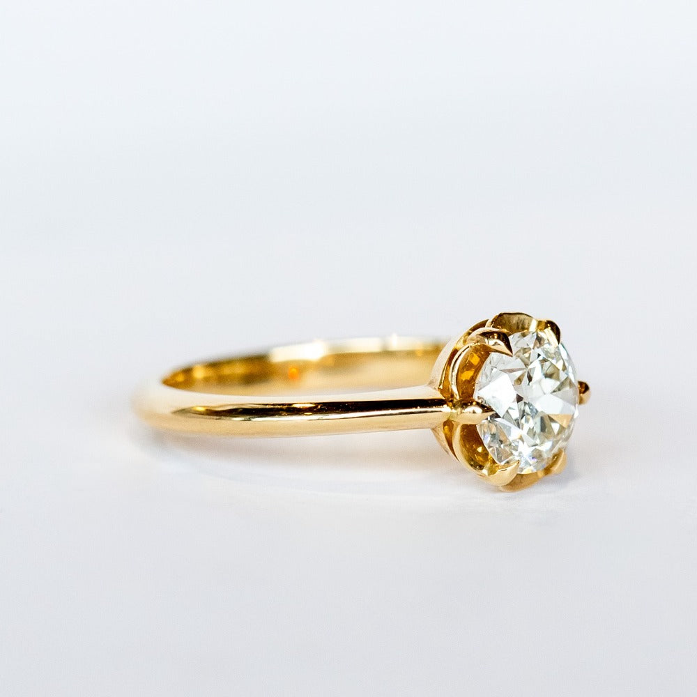 A yellow gold solitaire engagement ring with an old European cut diamond set in 6 dainty claw prongs.