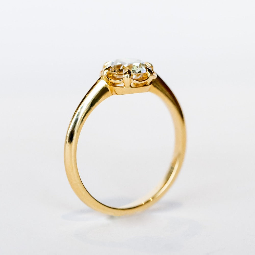A yellow gold solitaire engagement ring with an old European cut diamond set in 6 dainty claw prongs.
