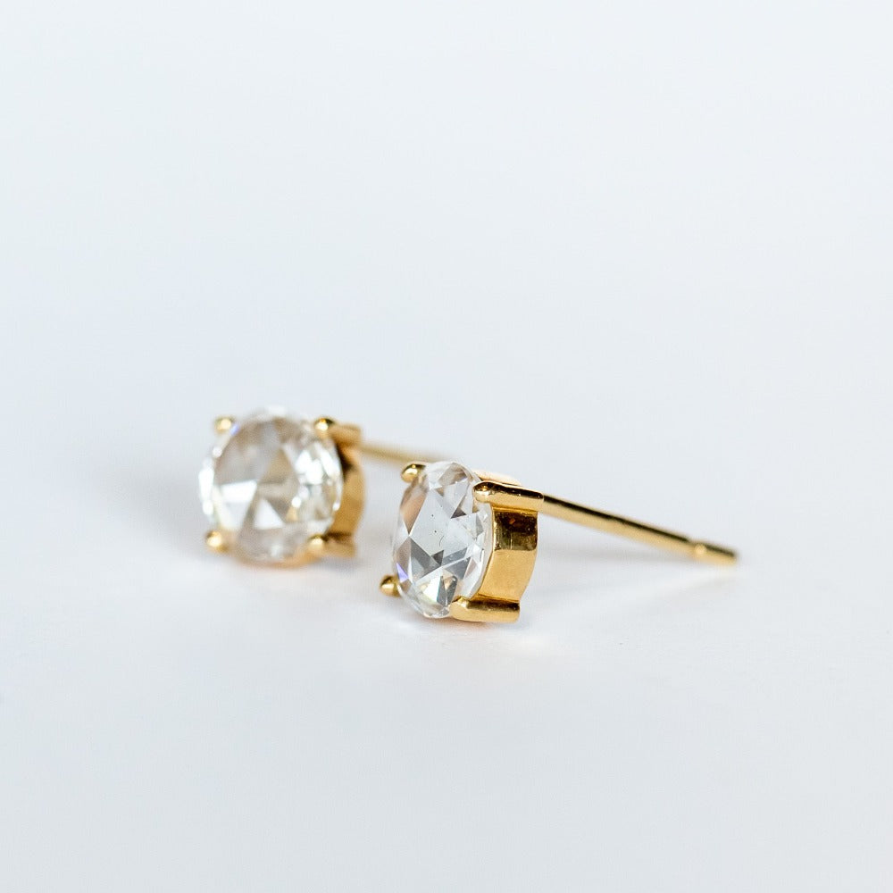 Round, rose cut diamond stud earrings in yellow gold prong mountings with post and push backs.