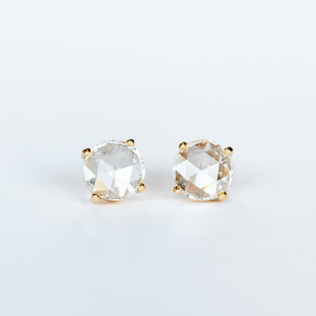 Round, rose cut diamond stud earrings in yellow gold prong mountings with post and push backs.