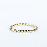 A white gold wedding band made up of two twisted strands with a polished finish.