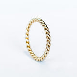 A white gold wedding band made up of two twisted strands with a polished finish.