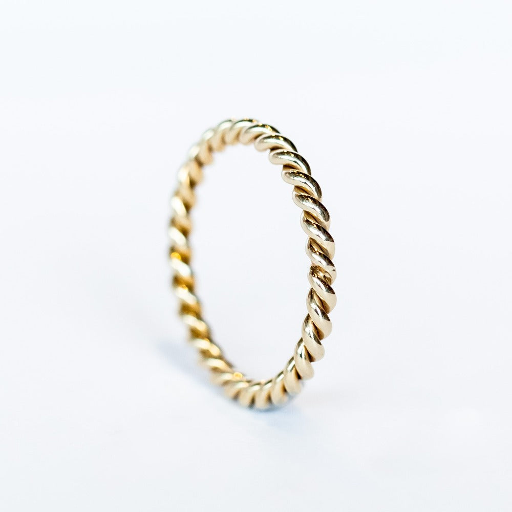 A white gold wedding band made up of two twisted strands with a polished finish.