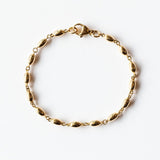 A solid gold oval link chain bracelet.