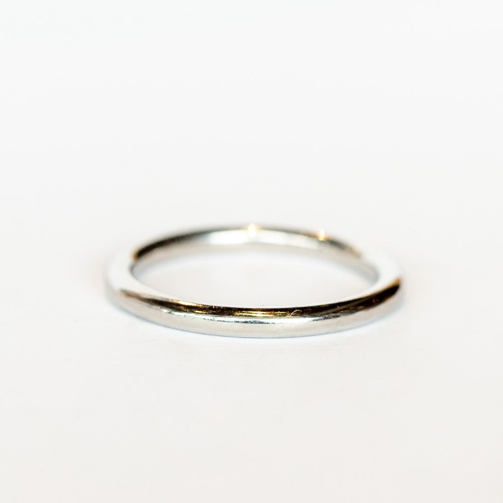 A rounded profile, polished platinum wedding band.