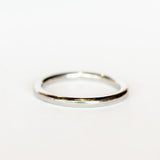 A rounded profile, polished platinum wedding band.