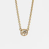 A bezel set cushion cut diamond in yellow gold on a cable chain necklace.