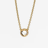 A round rose cut diamond bezel set in a station style necklace with classic gold cable chain.