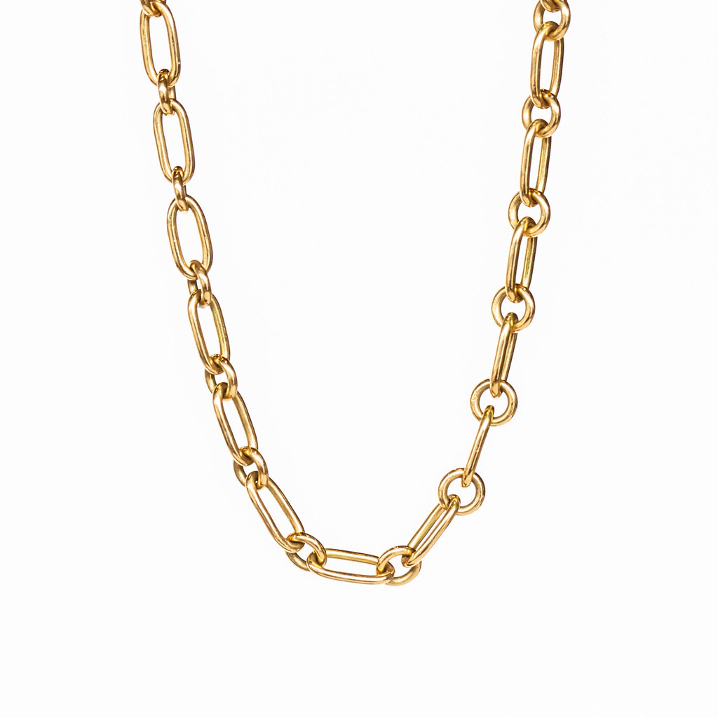 A gold chain necklace made up of alternating round and oval links.