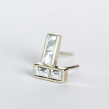 Diamond stud earrings featuring pairs of French cut diamonds bezel set in white gold with a post back.