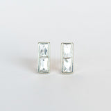 Diamond stud earrings featuring pairs of French cut diamonds bezel set in white gold with a post back.