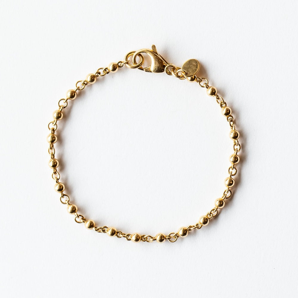 A rosary-like gold chain bracelet made up of ball-shaped solid gold links.