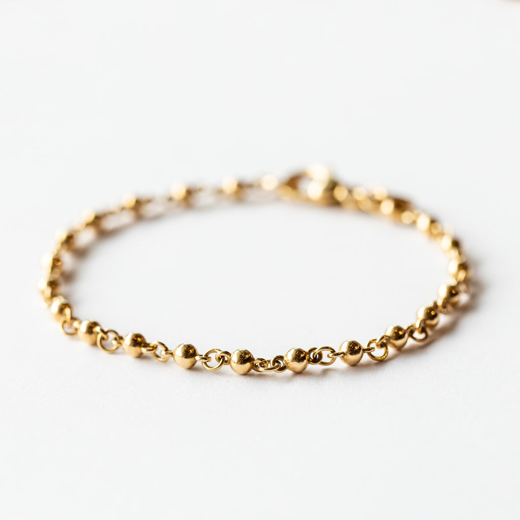 A rosary-like gold chain bracelet made up of ball-shaped solid gold links.
