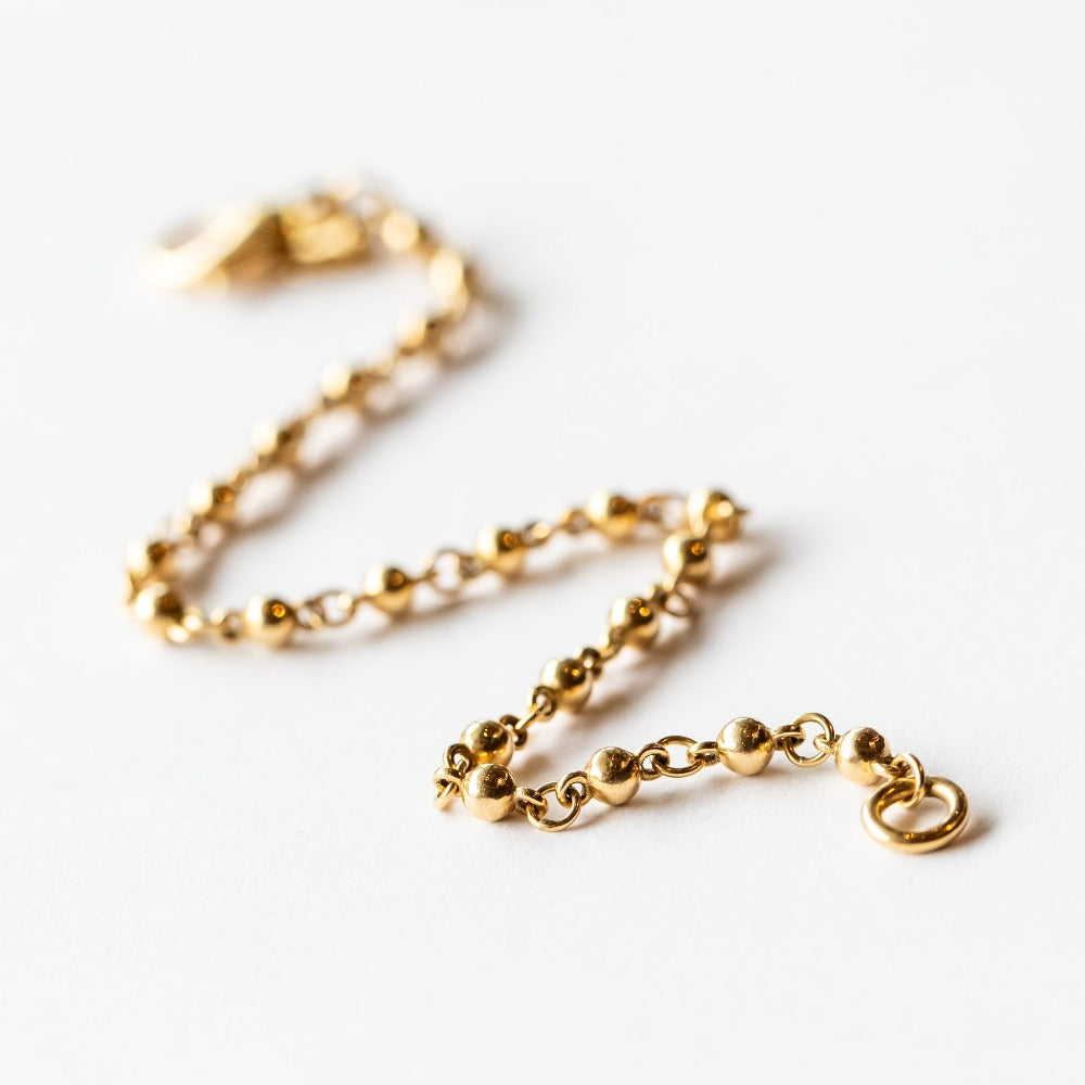 A rosary-like gold chain bracelet made up of ball-shaped solid gold links.