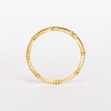 A yellow gold diamond eternity band with a leaf pattern interspersed with tiny diamonds.