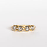 Four rose cut salt and pepper diamonds are set into a yellow gold band with beaded edge details.