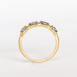 Four rose cut salt and pepper diamonds are set into a yellow gold band with beaded edge details.