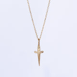 A tiny gold engraved dagger pendant necklace.
