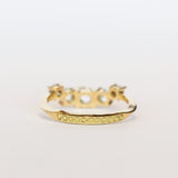 A diamond contour wedding band featuring five graduated size rose cut diamonds set in 18 karat yellow gold.