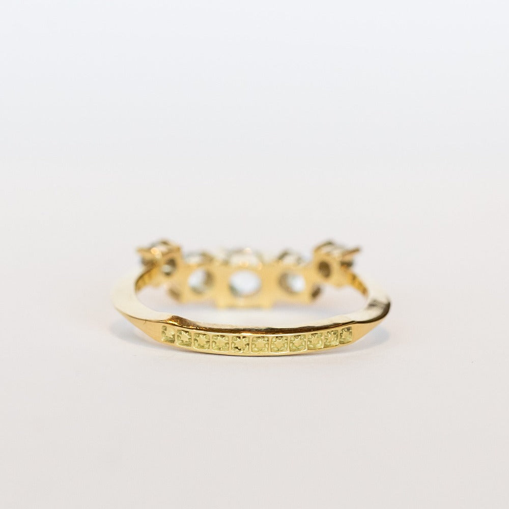 A diamond contour wedding band featuring five graduated size rose cut diamonds set in 18 karat yellow gold.