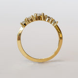 A diamond contour wedding band featuring five graduated size rose cut diamonds set in 18 karat yellow gold.